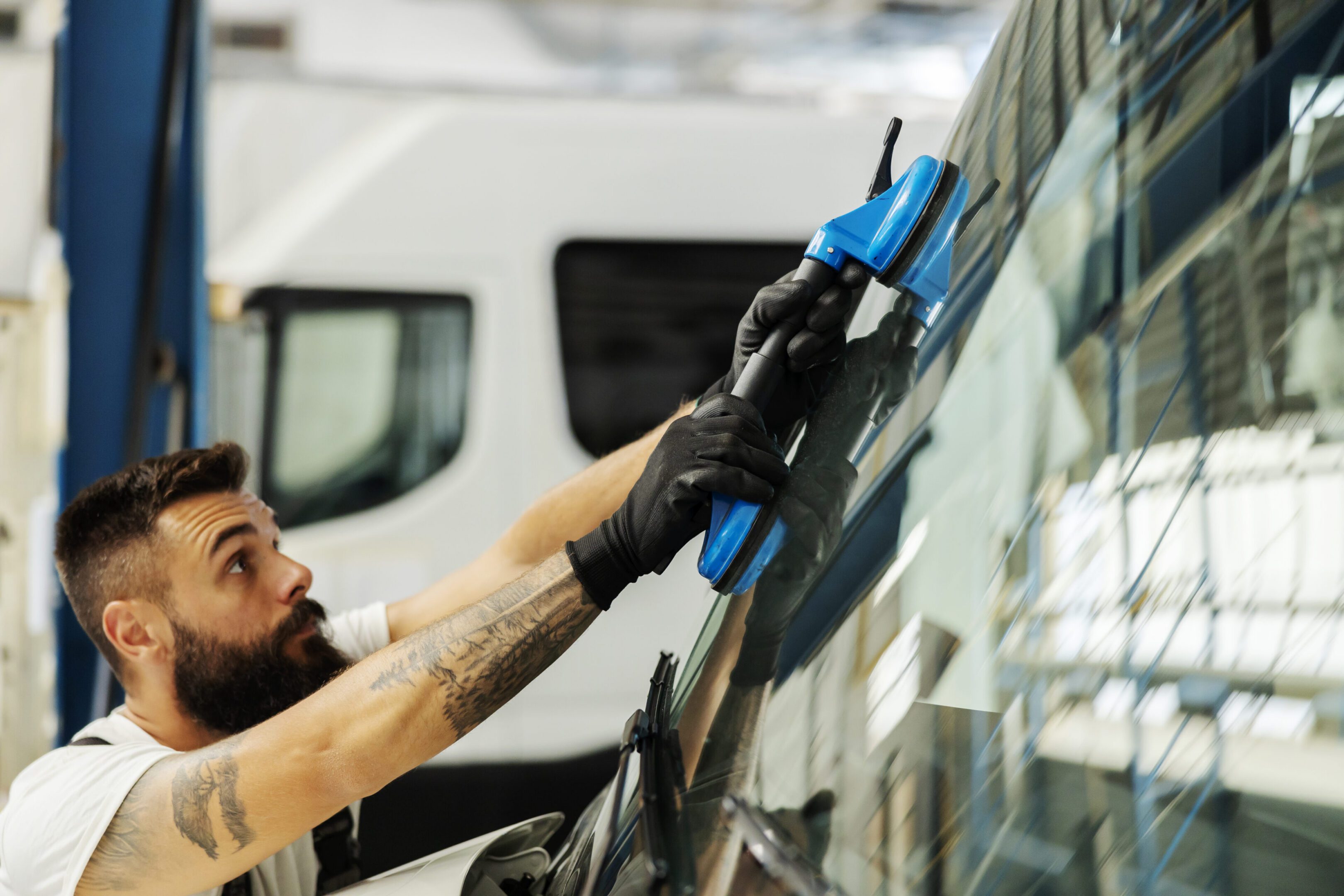 Technician fixing car glass