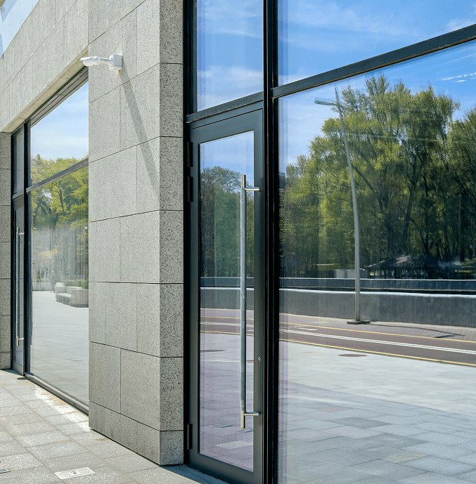 Modern glass building entrance with reflections